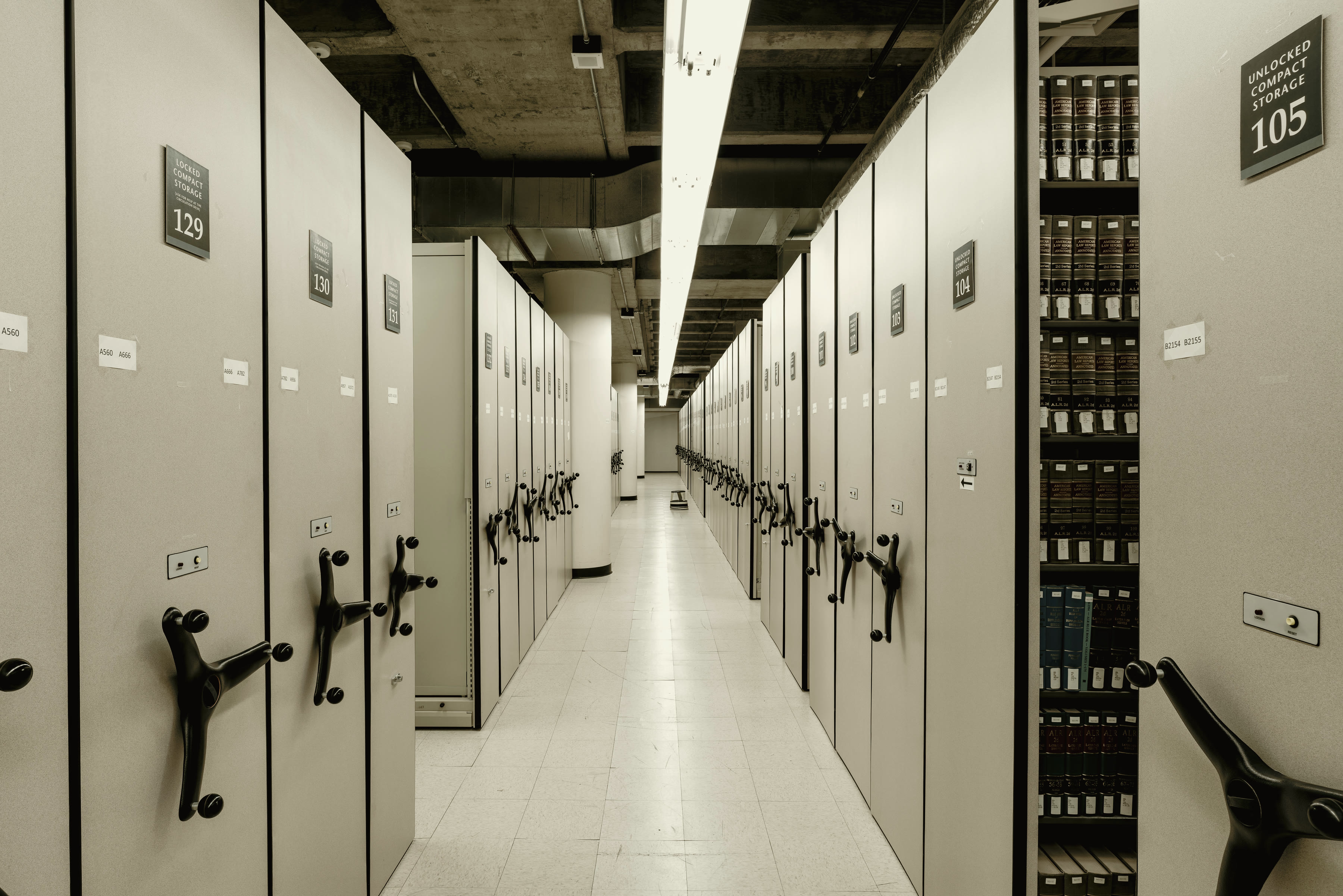 Rows of archived document boxes on storage shelving