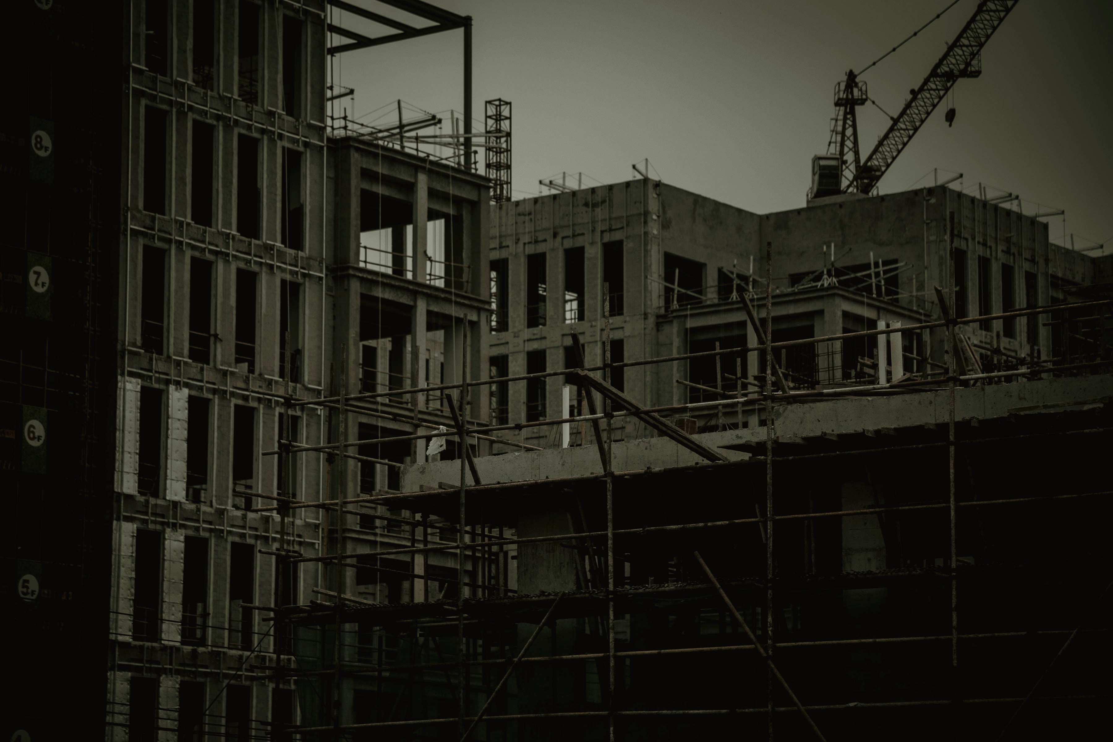 A construction site working under floodlights after dark.
